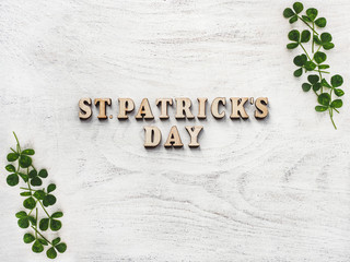 Wooden letters of the alphabet in the form of the words St. Patrick's Day lying on the table. View from above. Isolated background, wooden surface. Congratulations for relatives, friends, colleagues