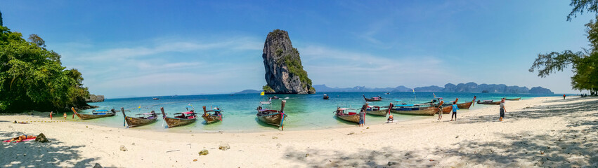 Fototapeta na wymiar Panorama view of longtail boat parked to wait for tourists at Ao Nang beach, Thailand..