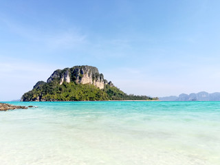 closeup and seascape view of island on Railay Bay on bright blue sky background.