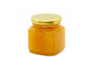 Glass jar with honey and lemon on white background