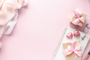 Gift box or gift box and flowers on pink table top view. Flat lay. Birthday, wedding, valentines day, march 8th concept. copy space