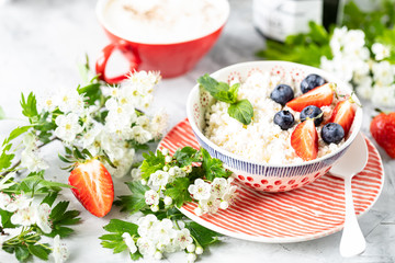 Cottage cheese with berries, jam, fresh strawberries and a cup of coffee with cream for breakfast. The recipe for the holiday Valentine's Day. close-up