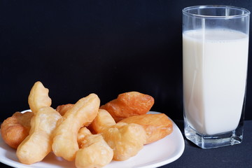 glass of milk and cookies on wooden table