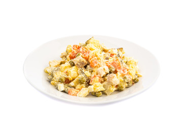 salad of different ingredients on a white plate on a wooden background