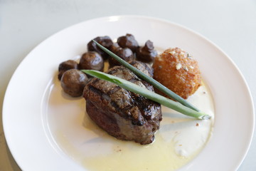 prime cut beef sirloin steak with sauteed mushrooms and hush puppy