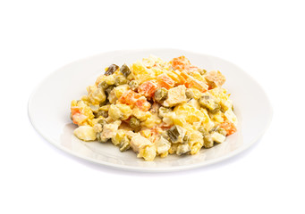salad of different ingredients on a white plate on a wooden background