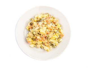 salad of different ingredients on a white plate on a wooden background