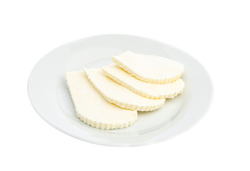 sliced white cheese on a white plate isolated