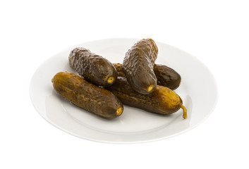 pickled three cucumbers on a white plate isolated