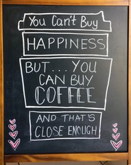 A amusing sign relating happiness to coffee.