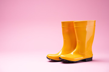 Yellow Rubber Boots On Pink Background