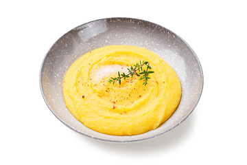 Homemade Polenta with butter and fresh thyme. isolated on white background