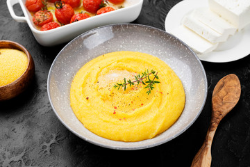 Homemade polenta with grilled cherry tomatoes and ricotta cheese.