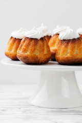 Homemade  dessert rum baba decorated with whipped cream.