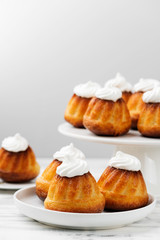 Homemade  dessert rum baba decorated with whipped cream.