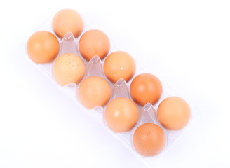 Tray of raw eggs isolated on a white background