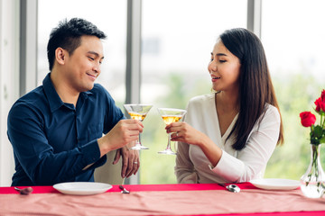 Romantic young happy couple relax talking and drinking wine glasses celebrate together in the restaurant