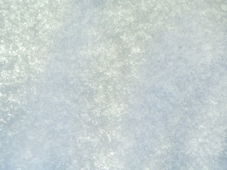 The background of white snow. The texture of the snow in the winter. Morning snow with shadow.