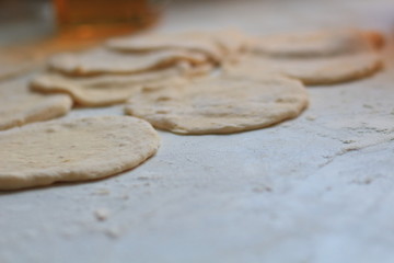 unrolled flat cakes of dough