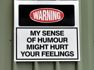 An amusing sign attached to a building warning "My sense of humour might hurt your feelings"