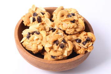 Chocolate homemade pastry biscuits in wooden bowl on white background