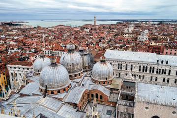 Fototapeta na wymiar Panoramic top view on the domes of the Cathedral of San Marco and the rooftops of Venice.