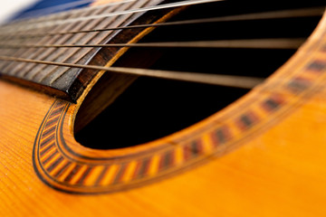 Close up of classical guitar's sound hole and strings