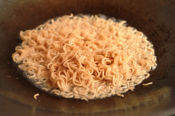 Instant noodle cooked in a saucepan