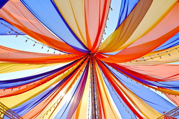Look up the roof of a circus tent or trade show tent. Beautifully decorated with bulbs. Tent pattern on a cloth texture