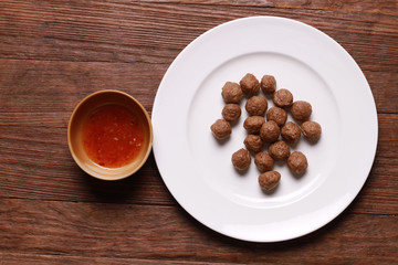fried meat ball and sauce on white dish