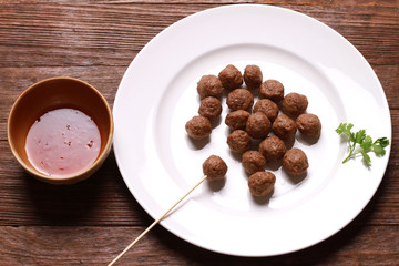 fried meat ball and sauce on white dish