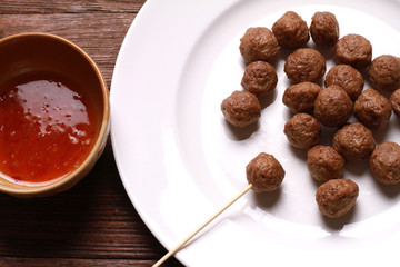 fried meat ball and sauce on white dish