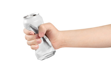 Hand holding crumpled aluminium can, isolated on white background