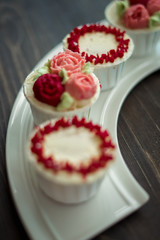 Beautiful cup cakes flowers from butter cream, in red and pink colour. Suitable for Birthday, Anniversary, Valentine Day and festive. selective focus