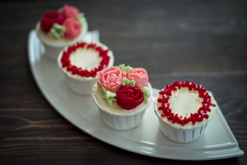Beautiful cup cakes flowers from butter cream, in red and pink colour. Suitable for Birthday, Anniversary, Valentine Day and festive. selective focus