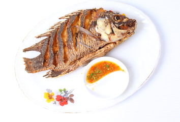 Fried fish isolated with spicy sauce in white background