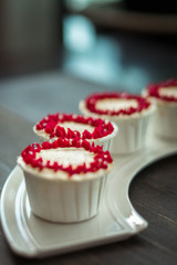 Beautiful cup cakes flowers from butter cream, in red and pink colour. Suitable for Birthday, Anniversary, Valentine Day and festive. selective focus