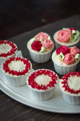 Beautiful cup cakes flowers from butter cream, in red and pink colour. Suitable for Birthday, Anniversary, Valentine Day and festive. selective focus