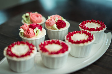 Beautiful cup cakes flowers from butter cream, in red and pink colour. Suitable for Birthday, Anniversary, Valentine Day and festive. selective focus