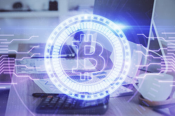 Double exposure of blockchain theme hologram and table with computer background. Concept of bitcoin crypto currency.