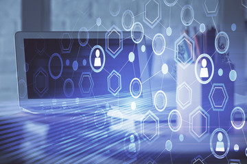 Computer on desktop with social network hologram. Multi exposure. Concept of international people connections.