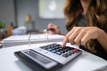 Businesswoman Calculating Bills