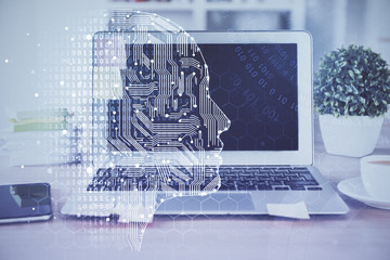 Double exposure of table with computer and brain hologram. Data innovation concept.