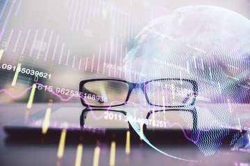 Financial graph hologram with glasses on the table background. Concept of business. Double exposure.