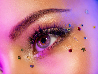 Colorful makeup. Bright and intense makeup. Female eye close-up with bright makeup. Fashionable...