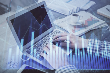 Double exposure of forex graph with man working on computer on background. Concept of market analysis.