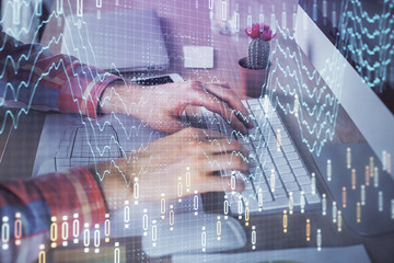 Double exposure of stock market chart with man working on computer on background. Concept of financial analysis.