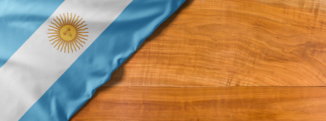 National flag of Argentina on a wooden background with copy space