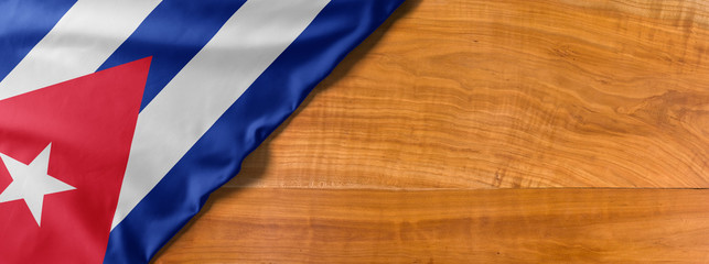 National flag of Cuba on a wooden background with copy space
