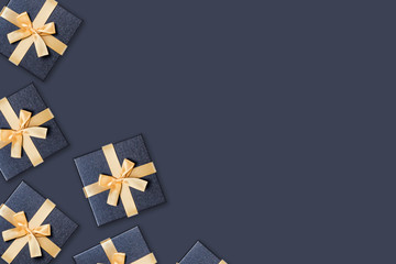 Festive card. Grey gift boxes with gold bow on the same color background. Flat lay, top view, copy space.